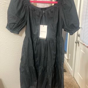 Black Who What Wear tiered mini dress with puff sleeves and pockets.